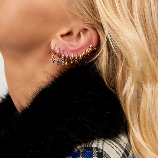 girls are wearing gold huggie earring