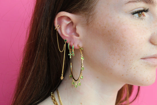 she is wearing gold huggie earring