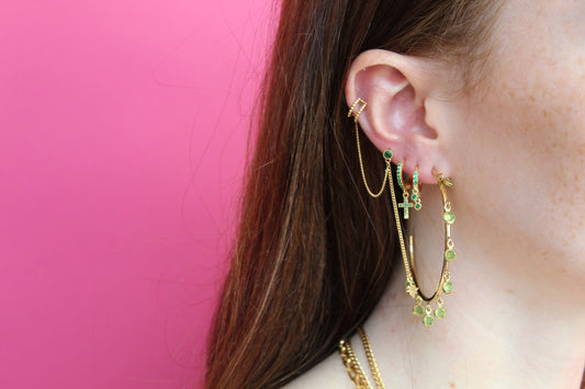 Girl is wearing Gold Huggie Earrings