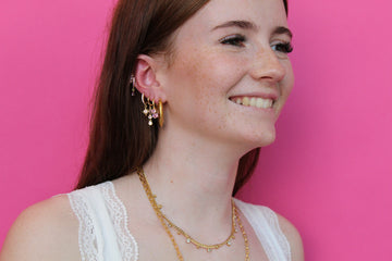 she is wearing gold huggie earring