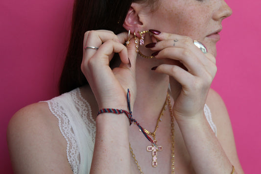 she is wearing gold huggie earring