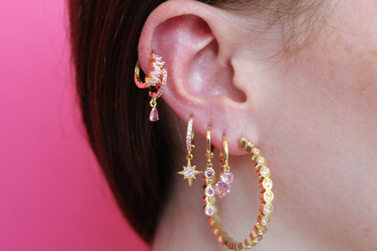 girls are wearing gold huggie earring