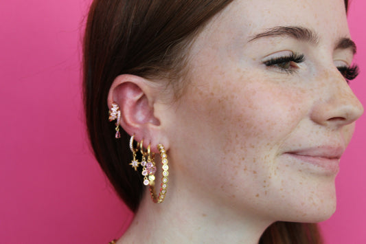 she is wearing gold huggie earring 
