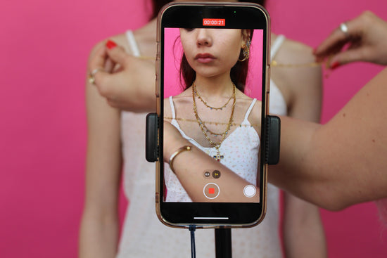 girl in the camera is wearing gold huggie hoop earrings