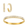 Bijoux De Mimi  Gold jewelry set featuring a huggie hoop earring and a matching bangle bracelet, both adorned with clear oval and round stones.