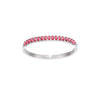 A Bijoux De Mimi silver bangle bracelet featuring a row of small oval-cut pink gemstones.