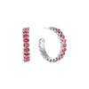 A pair of Bijoux De Mimi silver hoop earrings embellished with a row of oval pink gemstones.